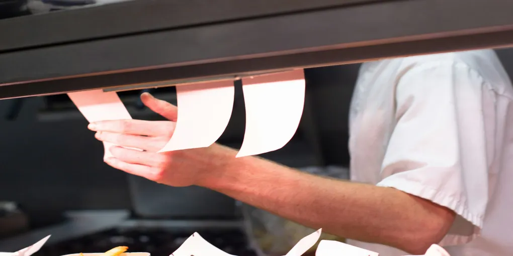 A man looking at a ticket to know when next to make.